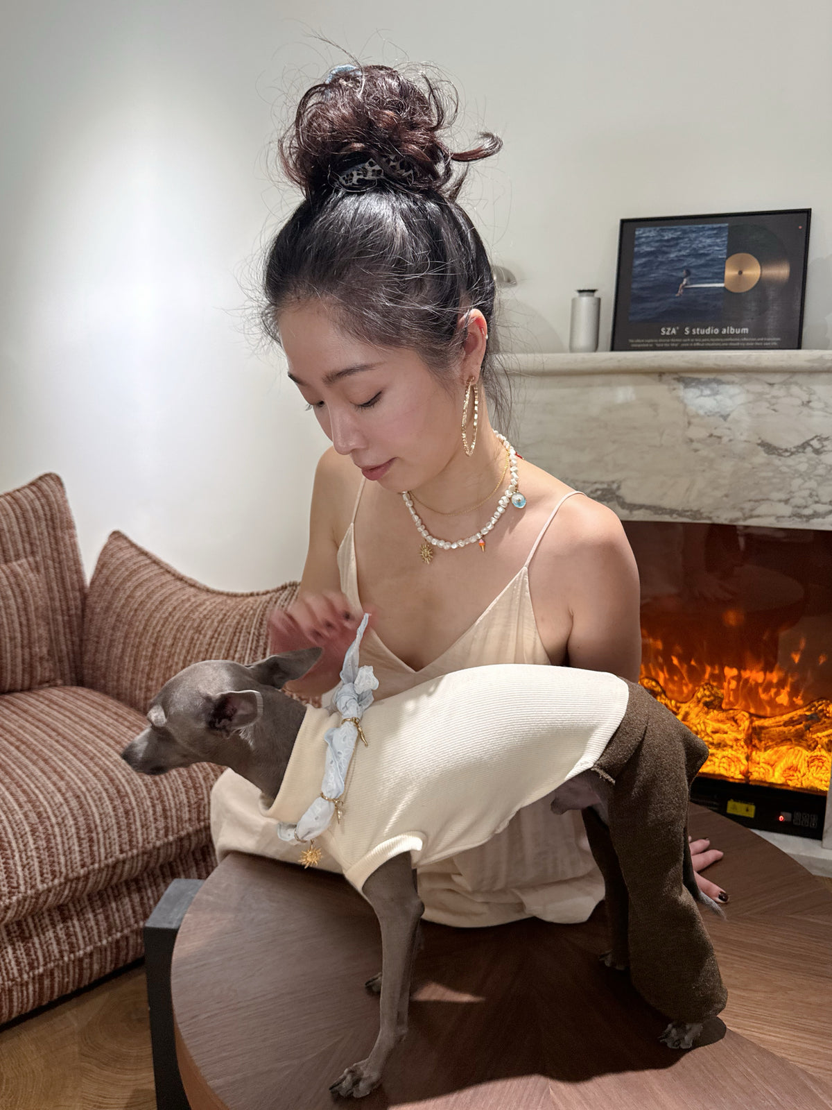 Woman in slip dress wearing the Thalassa matching shell necklace styling her Italian Greyhound in coordinating summer ocean pet collar
