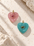 Pink strawberry quartz and green amazonite handmade crystal heart pet charms displayed side by side – Muttu
