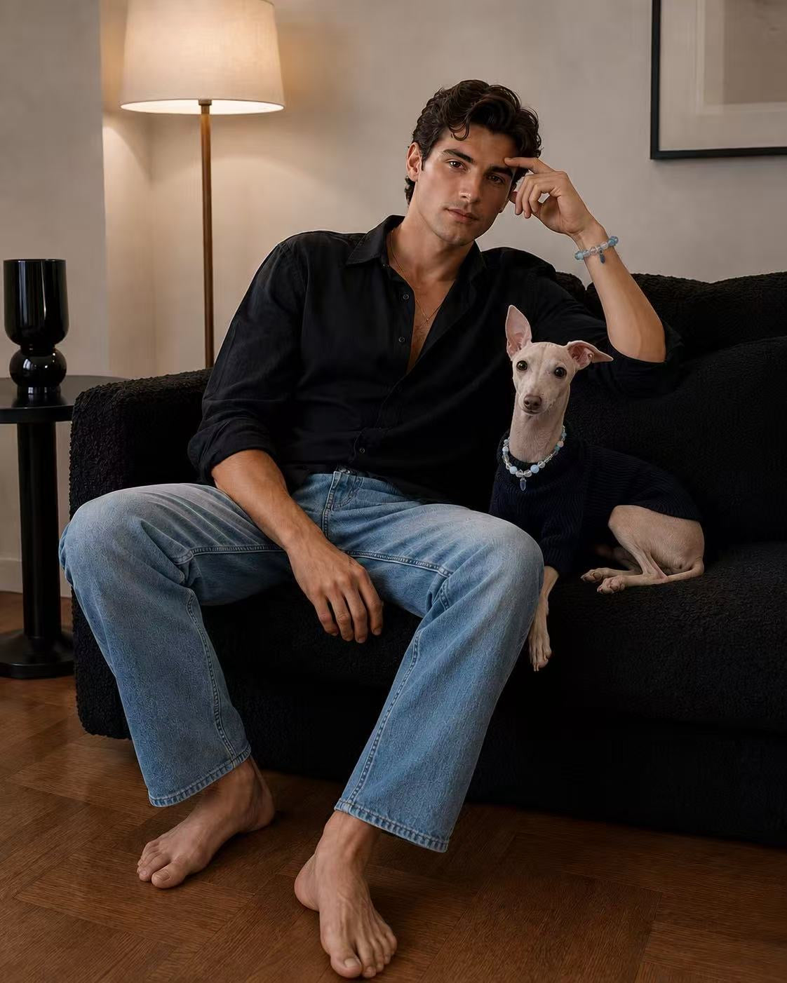 A stylish man and his Italian Greyhound sitting together on a black sofa. Both are wearing matching Muttu luxury accessories from The Matching Bond collection.