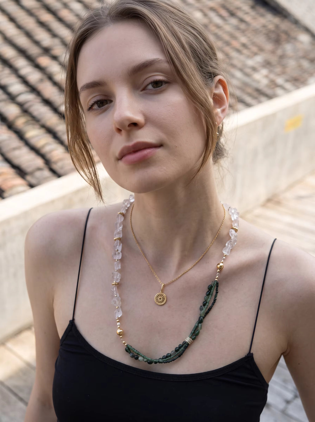 Forest Veil 2-in-1 crystal necklace on model in black top - dual-strand green jade and raw crystal quartz with gold medallion